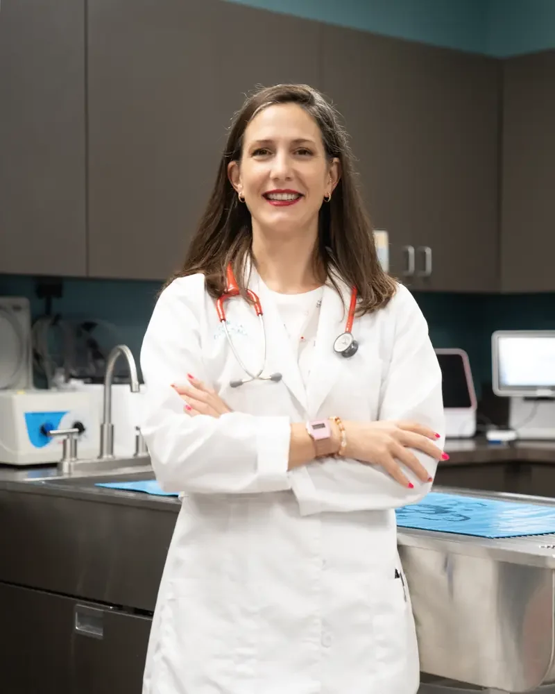 Dr. Kerrie Lewis examining a small dog patient